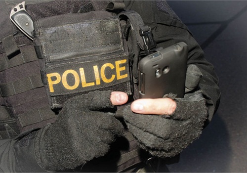 First responder using a rugged handheld device in the field